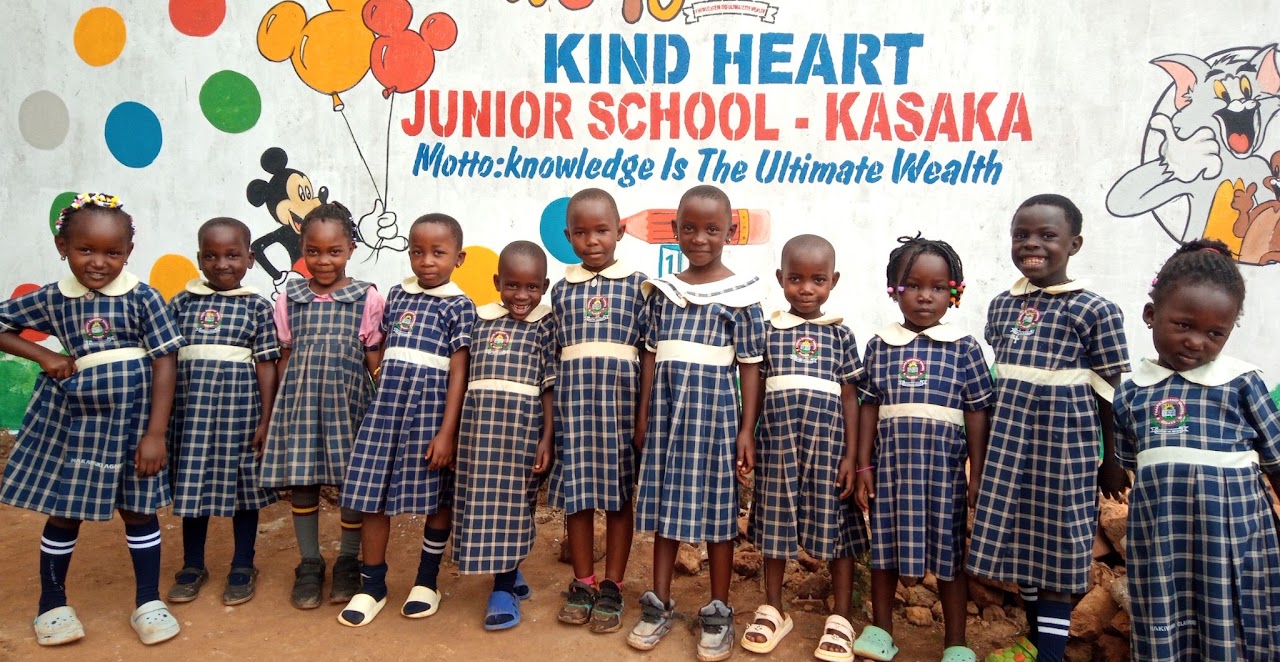 Pupils lined up in front of the school sign
