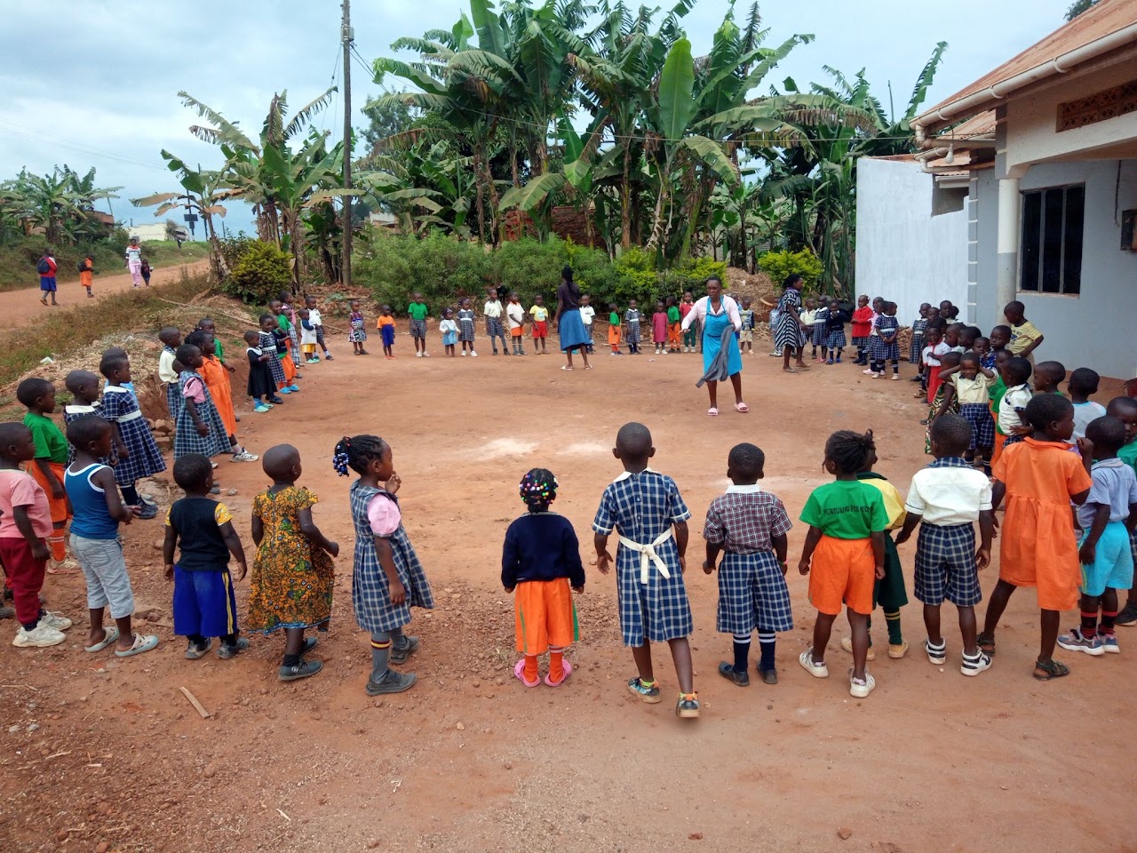 Pupils playing in a circle in the school compound